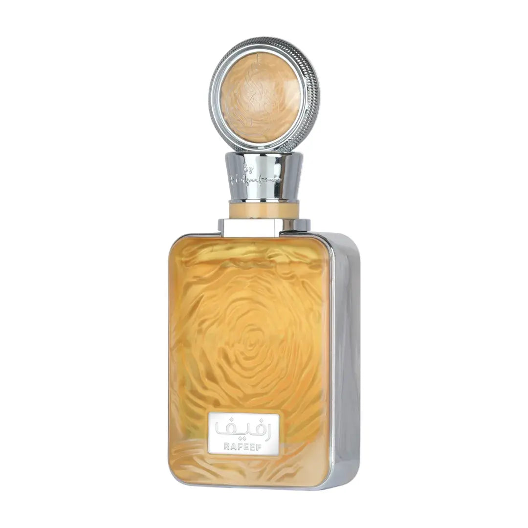 A rectangular perfume bottle with a silver-toned frame and cap, filled with a warm amber liquid featuring a swirling wood-grain pattern. The bottle has a white label at the bottom with Arabic script and the brand name 'RAEFY'.